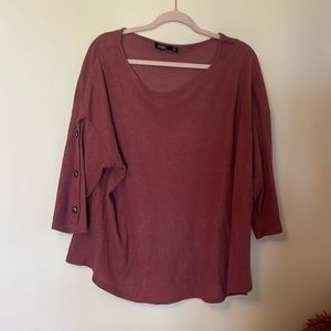 3 quarter length shirt. Has buttons on the sleeves.